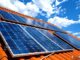 Solar panels installed on a rooftop under bright blue sky in Multan